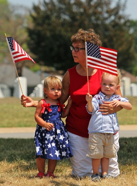 Marquita Rothrock and her grandchildren honor Chief Petty Officer Sean Patick Sullivan